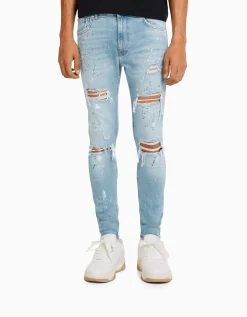 BERSHKA Jean skinny déchirures taches de peinture Bleu lavé Hot